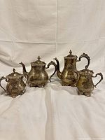 All four EPNS tea service pieces grouped together