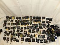 Wide shot showing entire lot of carded Axcess brooches spread out