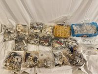 Overview of bin with many bags of watches and parts spread out