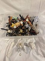 Plastic bin filled with assorted wristwatches and parts