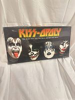 Front of sealed KISS-OPOLY box with band member faces