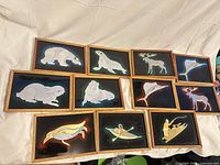 All 11 framed prints laid out for full lot view