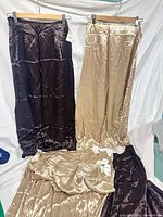 Group of satin skirts in brown and champagne laid out and hanging