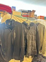Three jackets hung on hangers