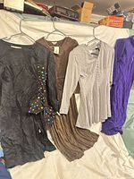 Overview of four vintage dresses hanging side by side