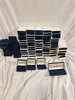 Stack of dark blue velvet jewellery boxes