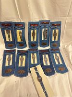 Front view showing all ten denim-pouched watches