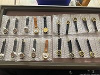 Tray showing all 24 watches arranged on bubble wrap