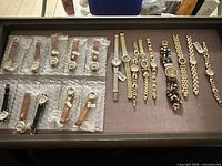 Tray showing entire assortment of leather-strap and bracelet watches