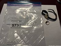 Overall view of watch and ring in bag