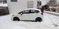 Driver side view of Honda Fit in snow