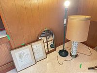 Group shot showing mirror, two botanical prints, green metal floor lamp, ceramic table lamp with shade