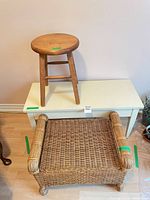 Stool on bench with wicker ottoman in foreground