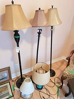 Overview of three floor lamps and two table lamp bases with shades