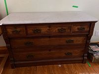 Front view showing full dresser, drawer layout, hardware, carved details