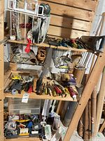 Full view of shelving with mixed tools and hardware