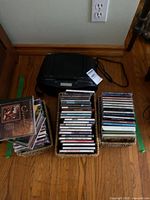Sony boombox with three baskets of CDs