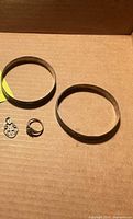 Lot overview showing two bangles, college ring, cross pendant
