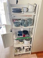 Full view of five-tier white folding shelf with contents (not included)