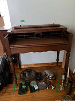 Front view of desk with top open and writing surface extended