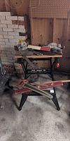 Workbench with hand plane, level, back saw and other tools visible
