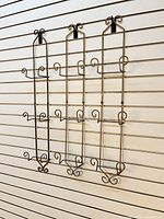 Front view of three matching metal towel racks hanging vertically