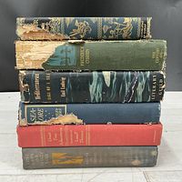 Stack of six vintage hardcovers showing spine titles, wear and dust jacket