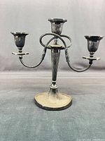 Full view of three-arm silverplate candelabra showing overall form and proportions