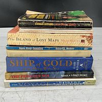 Stack of seven books showing spines for title confirmation