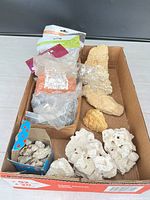 Full box view showing coral pieces, rocks and bagged gravel