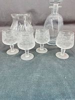 Group shot showing four cordial glasses, ewer, and decanter with stopper