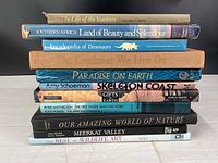 Stack of 11 natural history books spines visible