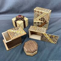 Group shot of all six puzzle boxes, various shapes and sizes