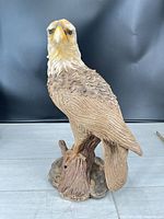 Front view of resin eagle sculpture on stump