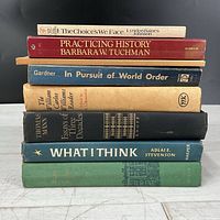 Stack of seven books showing spines and titles