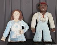 Both folk art cast concrete statues side by side