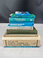 Stack of ten fish and marine life reference books
