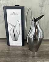 Pitcher next to branded box