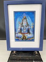 Front view of framed holographic image on pedestal