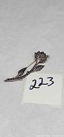 Front view of sterling silver marcasite rose brooch with lot number