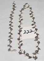 Necklace and bracelet laid flat showing full lengths and clasps