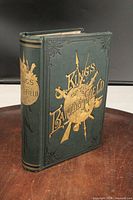 Front cover showing cloth color, gilt pictorial stamping and title