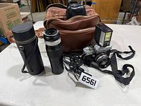 Full lot showing camera, flash, extra lens, case, bag and accessories