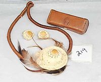 Necklace, earrings and leather lipstick case laid out together