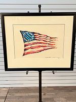 Full view of framed painting on stand