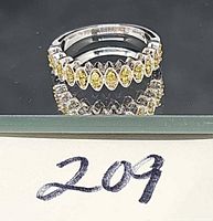 Top view of citrine ring reflecting on glass