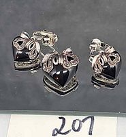 Front view of earrings and brooch showing heart stones and marcasite bows