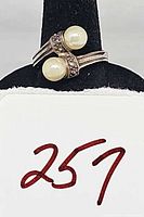 Front view of sterling silver bypass ring with two faux pearls and marcasite detailing