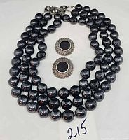 Necklace coiled with earrings in center, lot overview