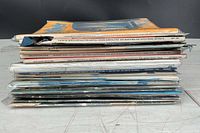 Side view of entire stack of magazines showing spine dates and wear